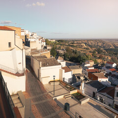 Ancient town hill side with levels of whitewashed houses and tiled roofs, Pisticci, Basilicata,...