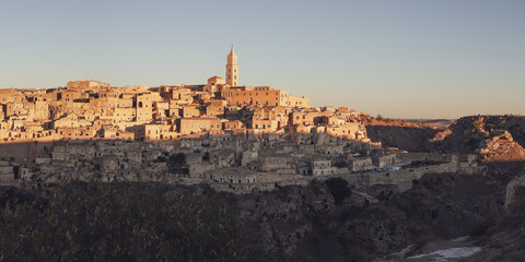 Ancient city on hill side with levels of limestone houses and tiled roofs, Matera, Basilicata, Italy