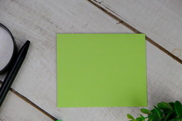 Home office workspace mockup with laptop, clipboard, palm leaf, notebook and accessories. Flat lay,...