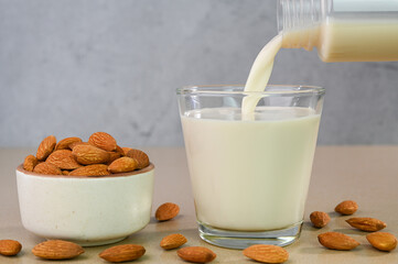 Serving almond milk in a glass cup.