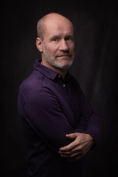 classic renaissance portrait in dark painterly style of a middle-aged business man with grey hair, baldness and short beard 
