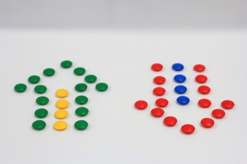 Up and down arrows created with colorful candy dots on a white background, representing direction, choice, and balance
