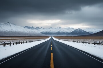 arafed road with snow and mountains in the background