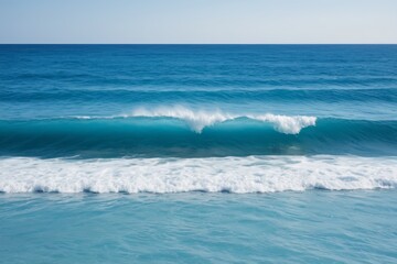 there is a large wave coming in to the shore of the ocean