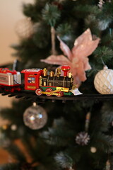 A beautifully festive Christmas Train Ornament displayed on a lovely decorated Tree
