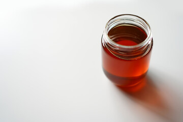 Honey Jug on Table and open lid. Premium Glassware and Bee Product Photography