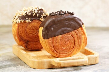 Delicious Cromboloni fusion croissants ,Round puff pastry filled with cream, topped with chocolate...