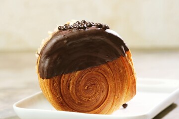 Delicious Cromboloni fusion croissants ,Round puff pastry filled with cream, topped with chocolate...