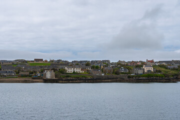 Fototapeta premium Scenic view of Stromness from the water on the Orkney Islands