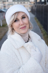 Elegant senior woman wearing winter clothes smiling outdoors