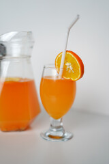 Refreshing Citrus Drink in Glass Jug and Glass. High-Resolution Image
