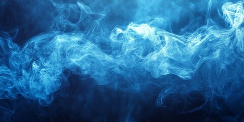 Obraz premium Blue soft smoke dances against a dark background, creating an intriguing abstract pattern. This blue soft smoke enhances the visual experience, making it perfect for artistic projects.