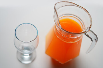 glass of orange juice with a glass cup