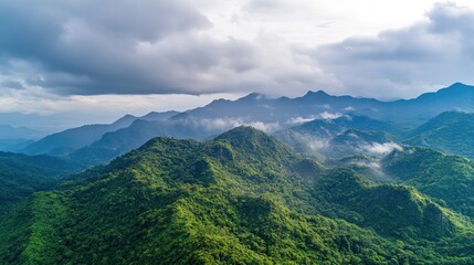 Aerial Enigma: Mysterious Mountains Veiled in Low Clouds with Dramatic Lighting