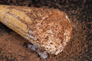 sweet melting white ice cream with chocolate chips in a waffle cone