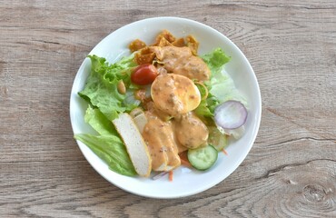 fresh vegetable topping boiled egg topping crispy fried taro dressing Indian sauce salad on plate 