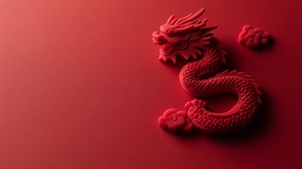 Obraz premium Elegant Red Dragon Sculpture on Vibrant Red Background, Symbolizing Power and Strength in Asian Culture