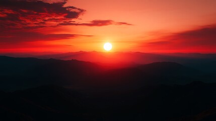 Fototapeta premium Fiery Sunset Over Silhouetted Mountain Ranges