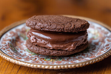 A chocolate cookie sandwich filled with creamy chocolate ganache