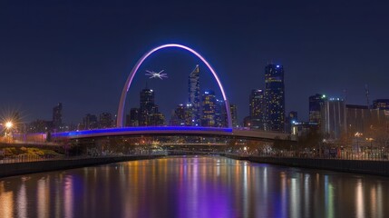 Night cityscape with illuminated arch bridge reflecting on calm water.