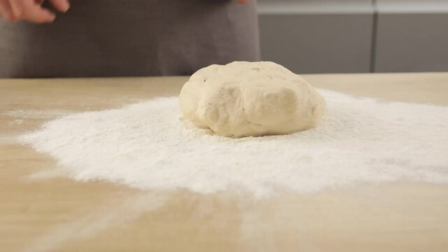 The dough crumbles in flour. Crumbling yeast dough in flour.