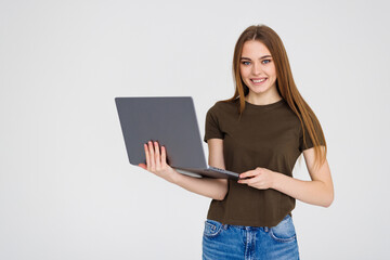 Young smilingwoman using laptop for remote work, e-learning at university college isolated in white...