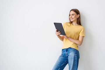 Young attractive woman hold tablet hand touch chin isolated over white background