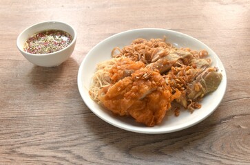 slice boiled and fried chicken dressing instant noodles and rice vermicelli topping garlic on plate dipping spicy seafood sauce