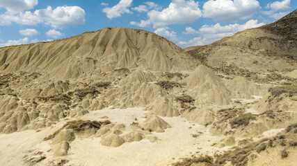 Aerial view of the Calanchi near Pisticci, in the province of Matera, Basilicata, Italy. Badlands are a type of dry terrain where sedimentary rocks and clay-rich soils have been eroded away.