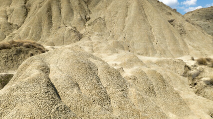 Aerial view of the Calanchi near Pisticci, in the province of Matera, Basilicata, Italy. Badlands are a type of dry terrain where sedimentary rocks and clay-rich soils have been eroded away.