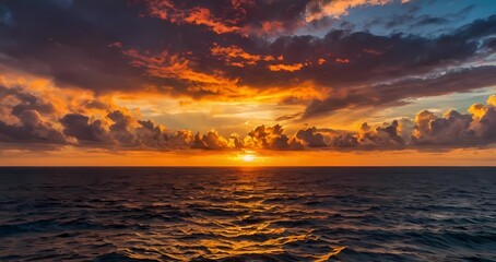 Fototapeta premium A dramatic sunset casting vibrant colors across the ocean horizon