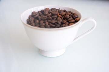 white antique cup of coffee with beans