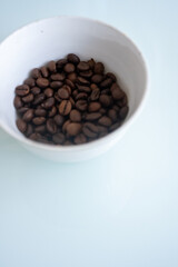 white cup of coffee beans