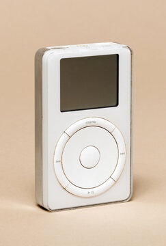 Pavia, Lombardy, Italy &ndash; November 2, 2024: Apple iPod 5 GB from 2001, first Apple music device. 
Design was inspired from Braun Radio T3, 1958. Shown at Ctrl+Alt Museum.