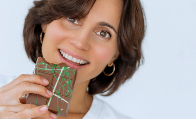 Close up of woman portrait eating Dubai chocolate with green pistachio paste, cream and kataifi...