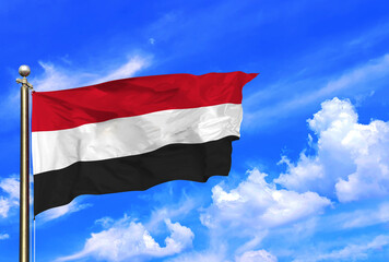 Yemen's Flag Waving Proudly Against a Clear Sky