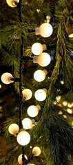 vertical photo of a garland hanging on a fir-tree, with big round light bulbs - close up image, abstract christmas tree