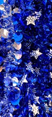 Beautiful vertical blue  abstract background with blue tinsels - base for a Christmas or New Year greeting card