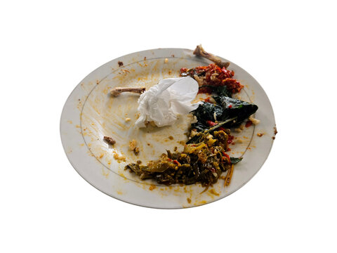 Used plate with leftover food remnants, including chicken bones, chili sauce, vegetables, and a crumpled tissue isolated on white background, transparent PNG