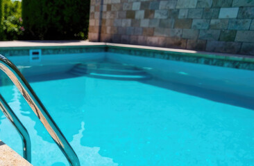 Obraz premium Bright summer pool with stone tiles and blue water