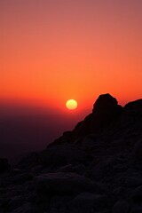 Obraz premium araffes on a mountain with a sunset in the background