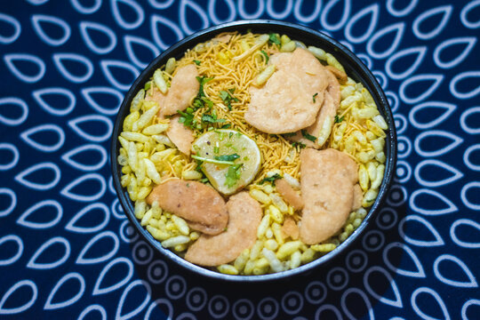 Delicious bhel puri, its a savoury snack originally from India, and is also a type of chaat. It is made of puffed rice, crumbled crunchy puri, onions, coriander .