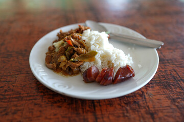 Thai food served with rice and chinese sausages on white dish. Southern of Thailand food