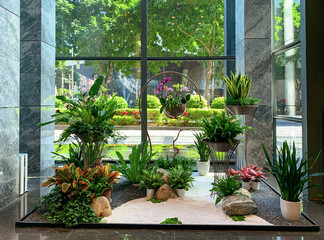 the small garden of blooming flowers and plants inside an office building lobby hall in shenzhen, china
