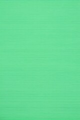 a close up of a green background with a single red object