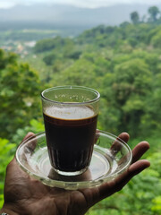 A cup of coffee while enjoying the beautiful mountain view.