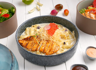 Fettuccine Alfredo with chicken sliced ​​steak. creamy sauce and pasta And grated cheese and...