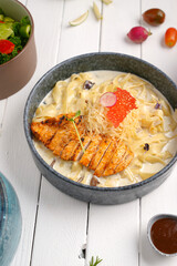 Fettuccine Alfredo with chicken sliced ​​steak. creamy sauce and pasta And grated cheese and Mushrooms create an appealing presentation for restaurant .