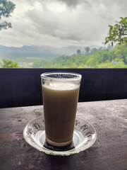 A cup of cow's milk while enjoying the beautiful mountain view.