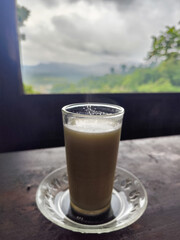 A cup of cow's milk while enjoying the beautiful mountain view.